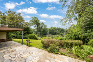 Expansive slate patio and terraced backyard