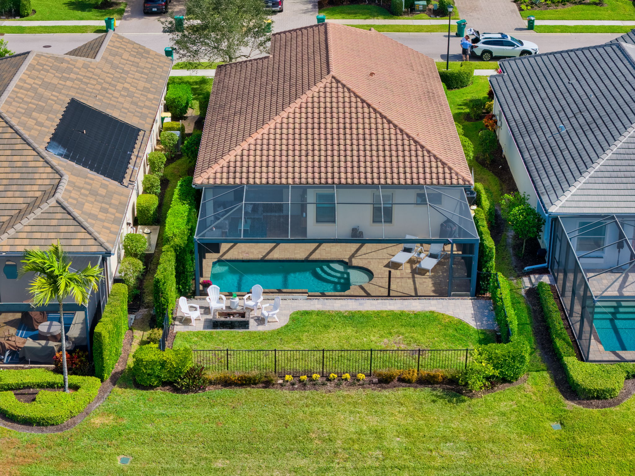 Aerial View Back of House Featuring Fire Pit and Fenced In Backyard