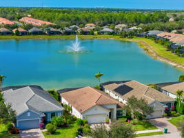 Aerial View of House Featuring Lake with Fountain