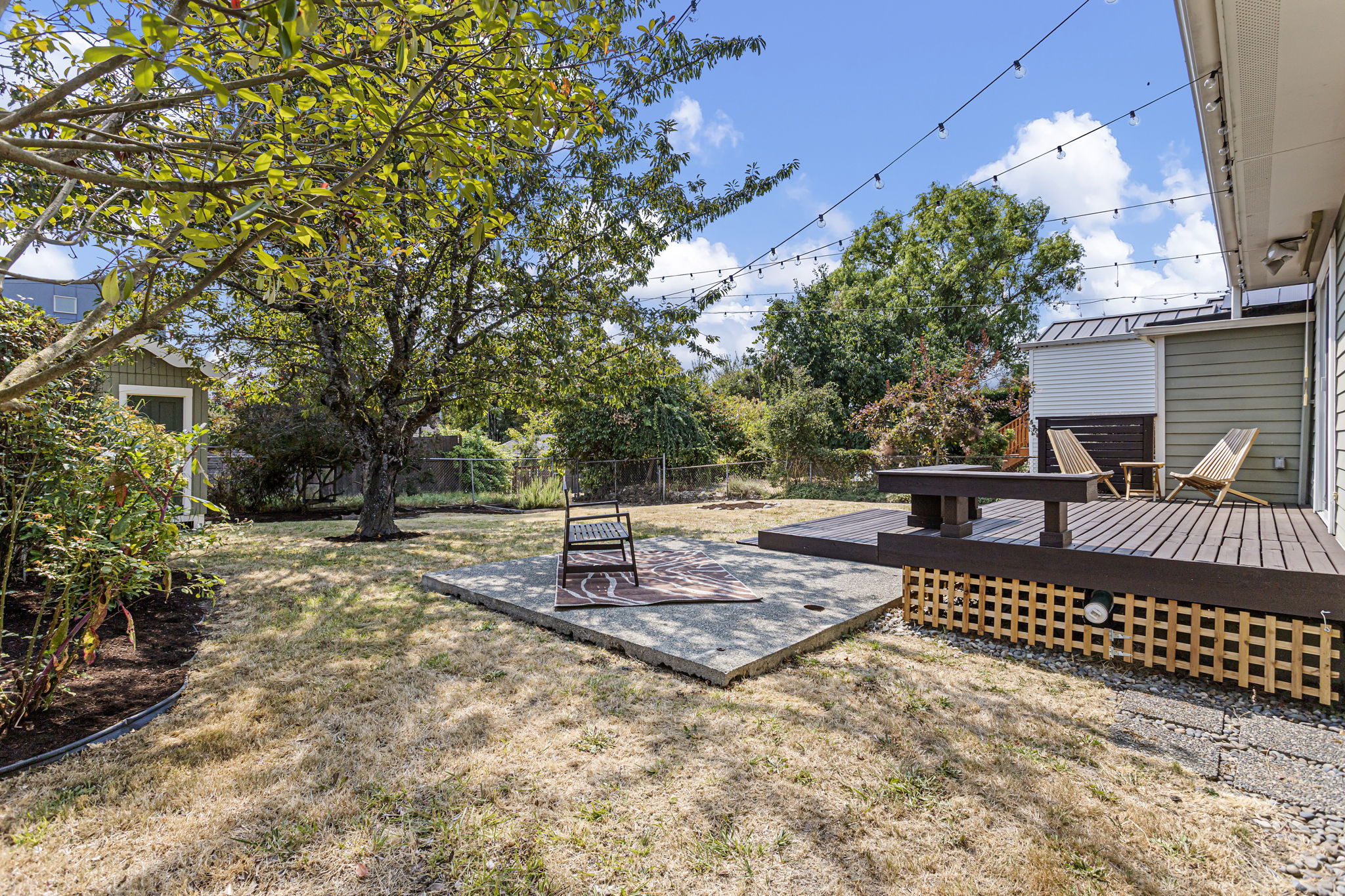 This is why the lot matters: enough open ground between deck, patio and shed for the backyard to feel like real territory—not leftover space.