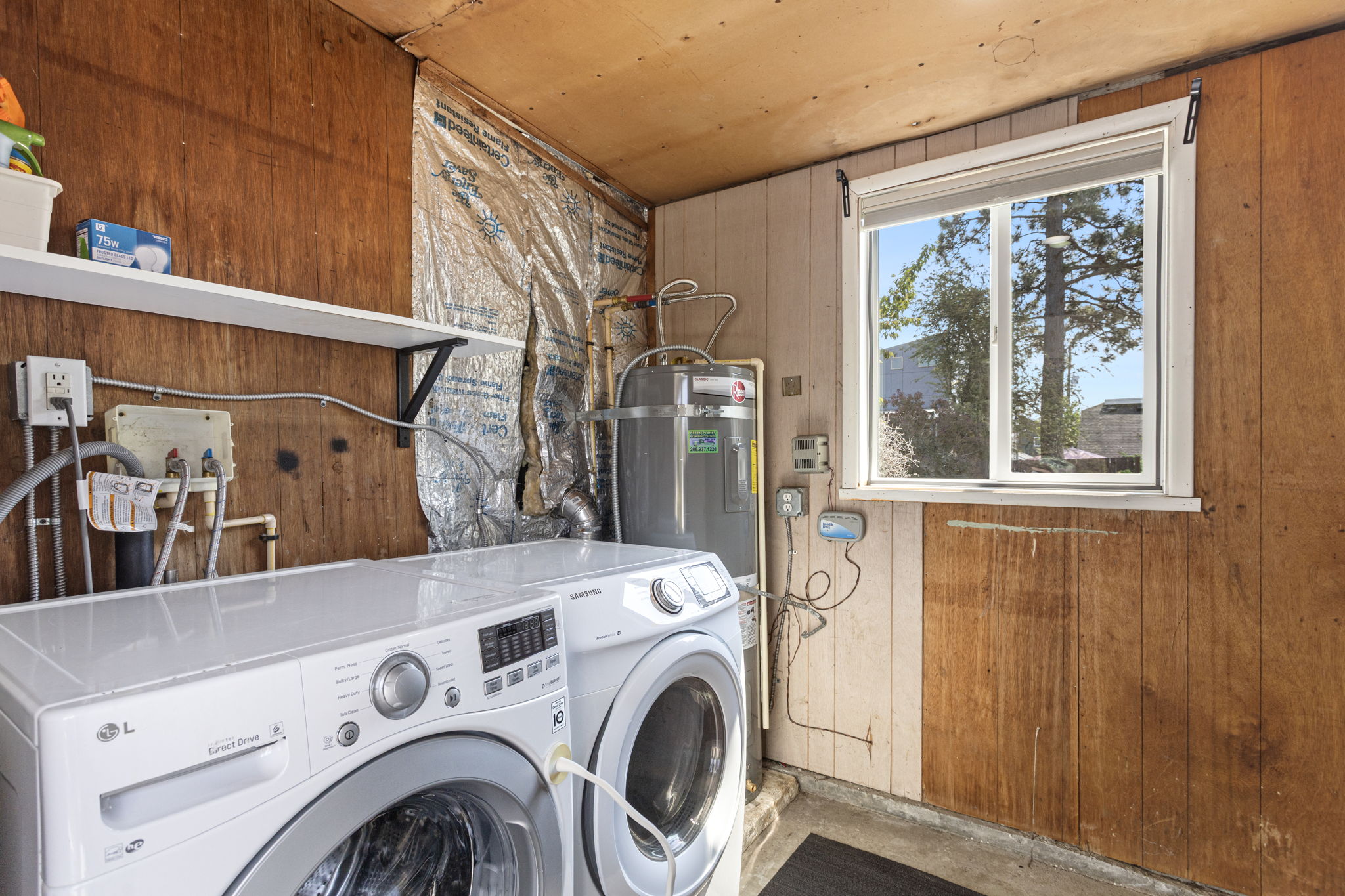 Outside the living area, this clean, dry, secure utility room adds the kind of support space a small house needs: daylight, included front-loading washer and dryer, plus included shelving and room for storage.