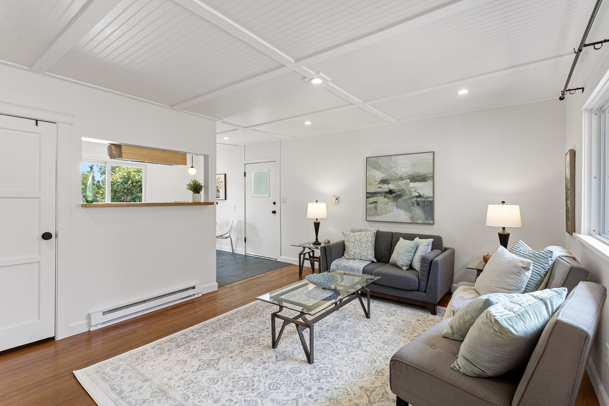 A full seating group fits without pinching the path through the house—one of those small-plan wins you can actually see.