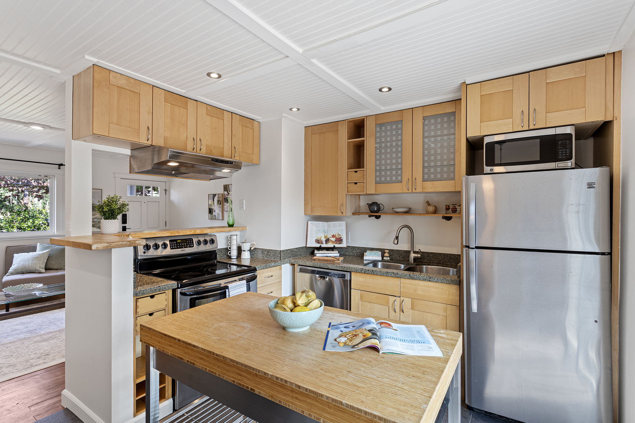 Sink, range and refrigerator are all within a step or two, with the worktable adding prep space in the middle.
