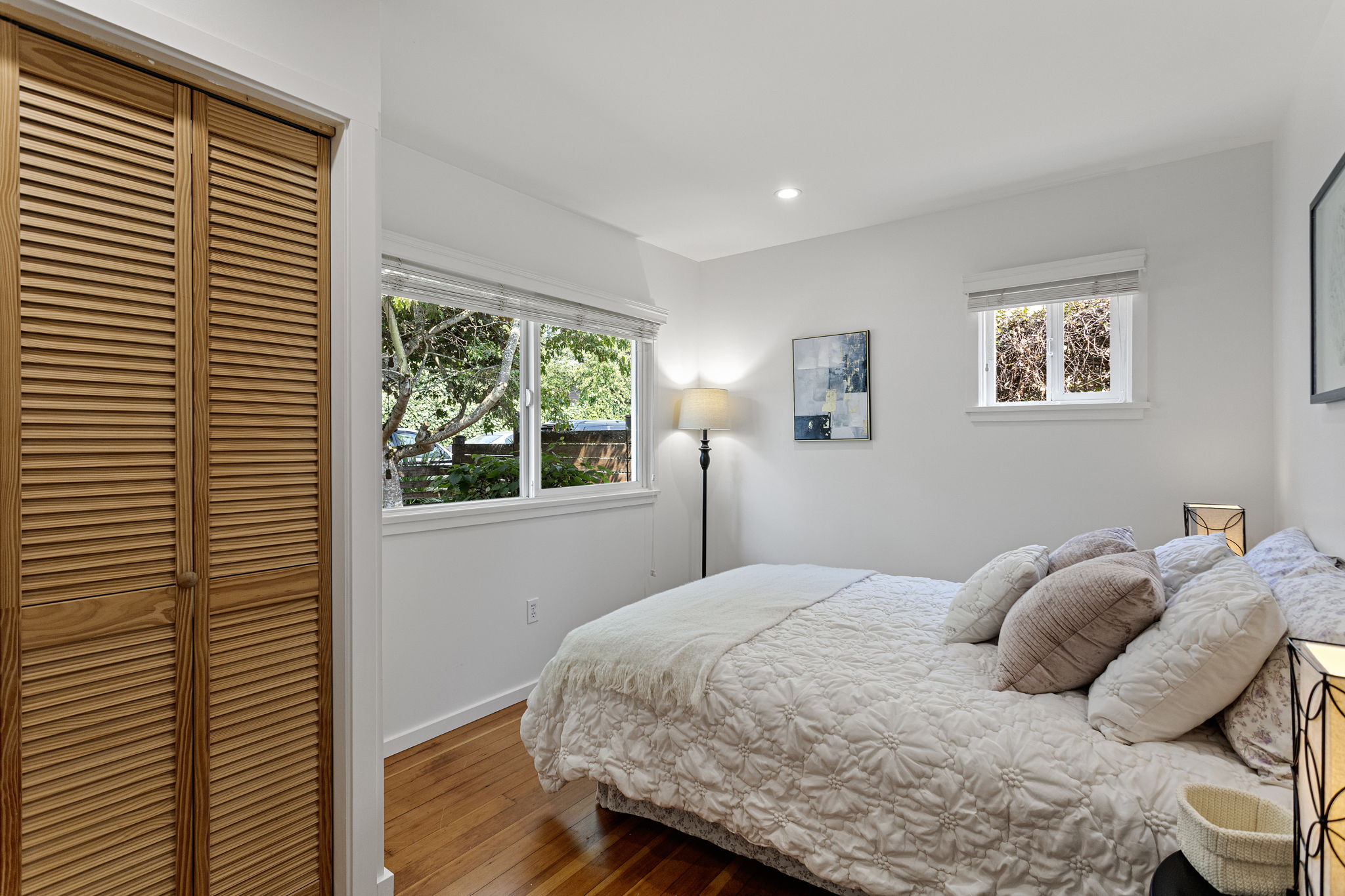 The prior occupant used this front bedroom as a home office—two exposures for daylight, and light rail nearby for the days the office isn’t at home.
