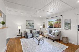 The front garden comes back into the room through the big window—leafy views and daylight pulled deep into the living space.