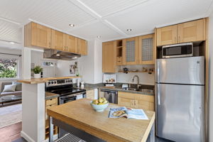 Sink, range and refrigerator are all within a step or two, with the worktable adding prep space in the middle.