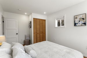 This angle shows the room’s proportions best: the bed fits comfortably, with clear circulation, usable wall space and morning light from the east-facing window.