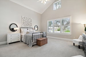Primary bedroom with vaulted ceilings