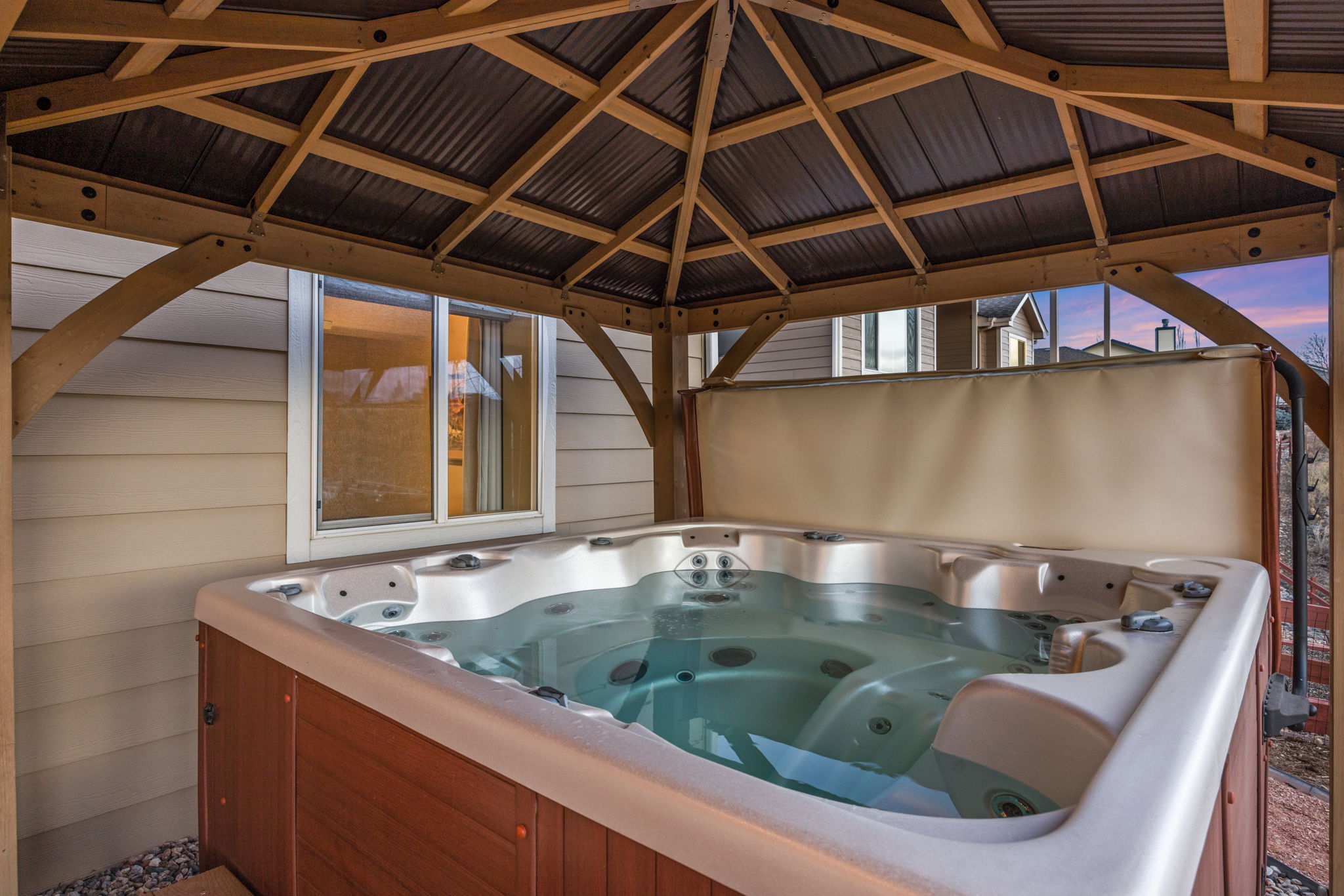 Covered hot tub is included