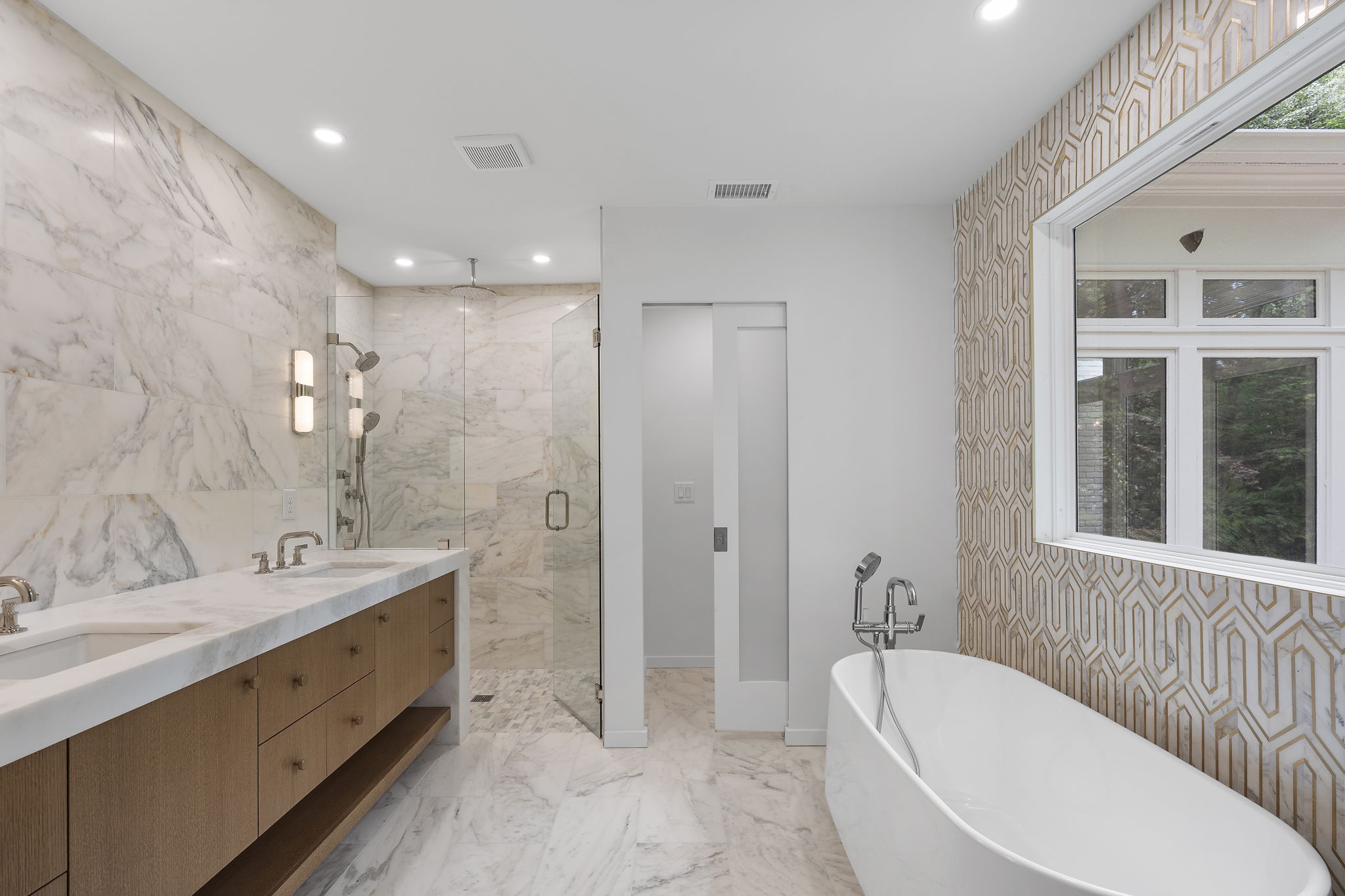 Primary bathroom clad in marble