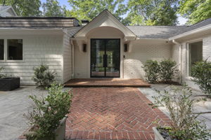 Double iron doors flanked with gas lanterns set the tone