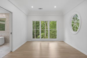 Primary bedroom sitting room with pool view
