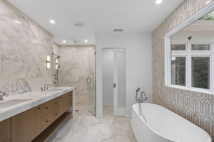 Primary bathroom clad in marble