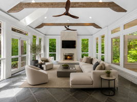 Screened porch with fireplace. Virtually staged