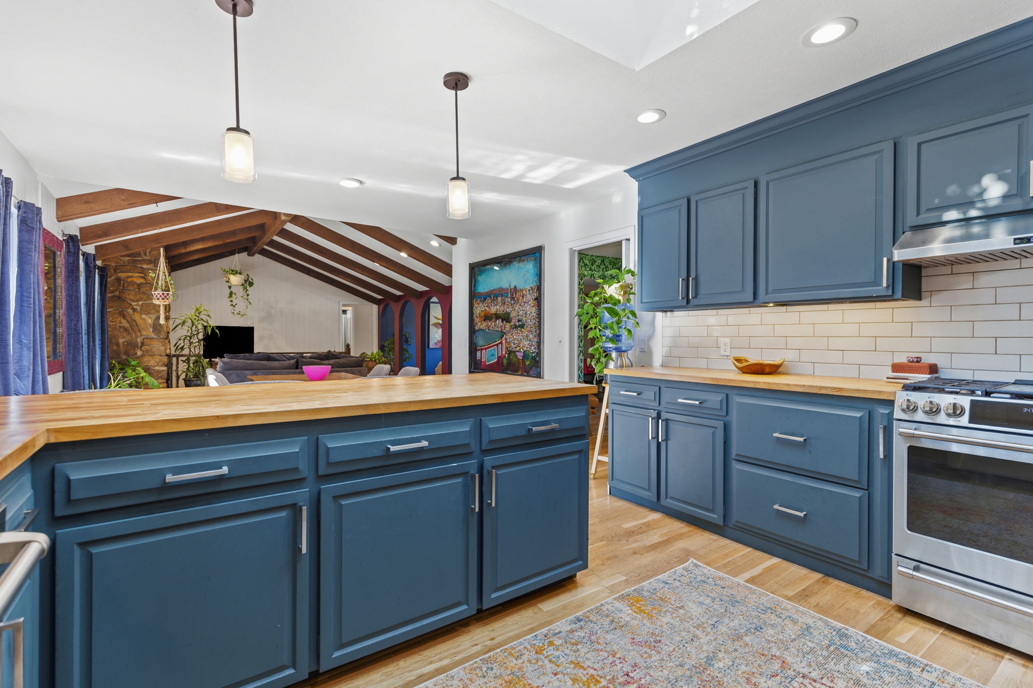 Gas range, range hood, and open view into the main living areas