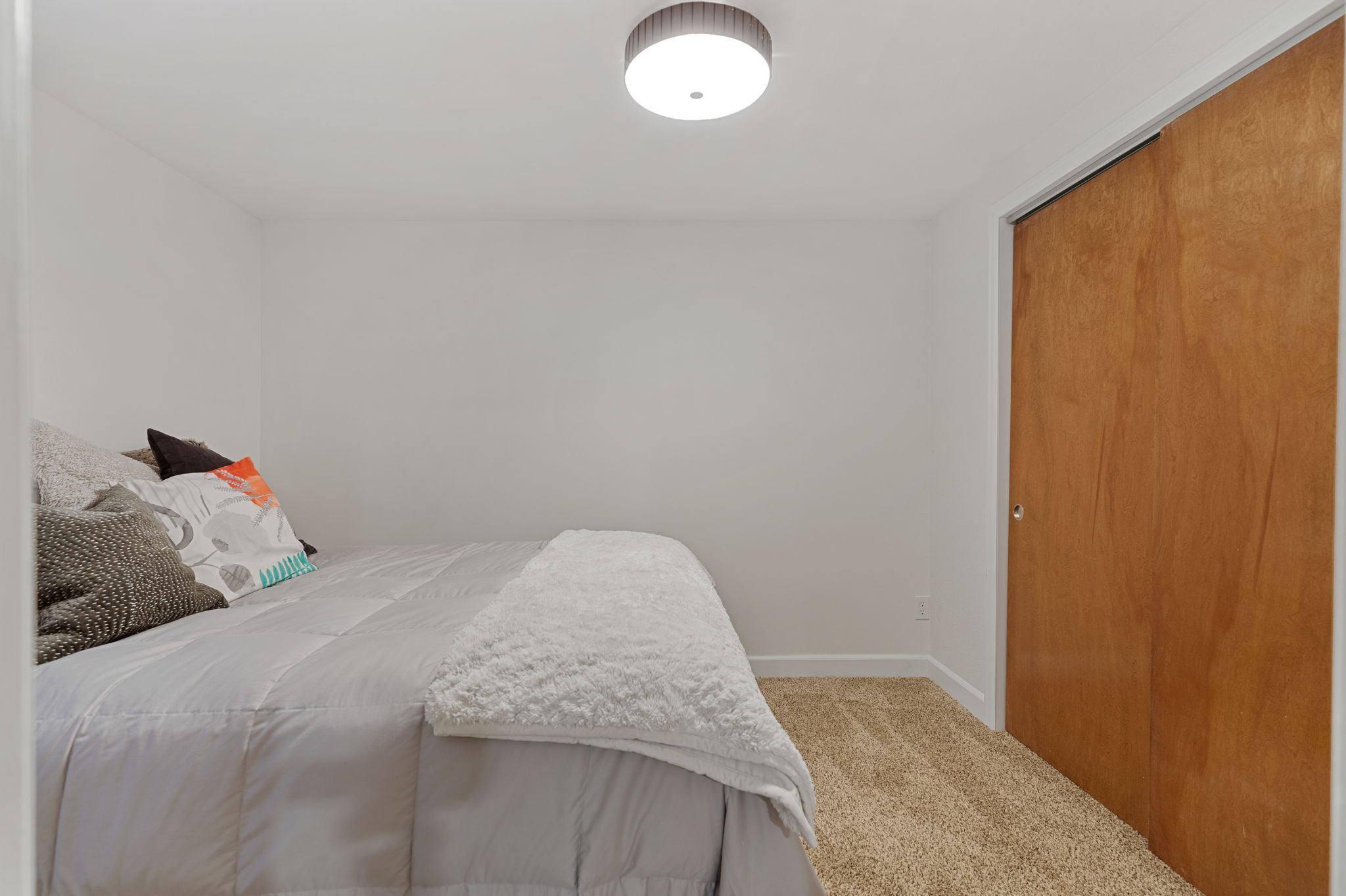Non-conforming basement bedroom featuring new carpet
