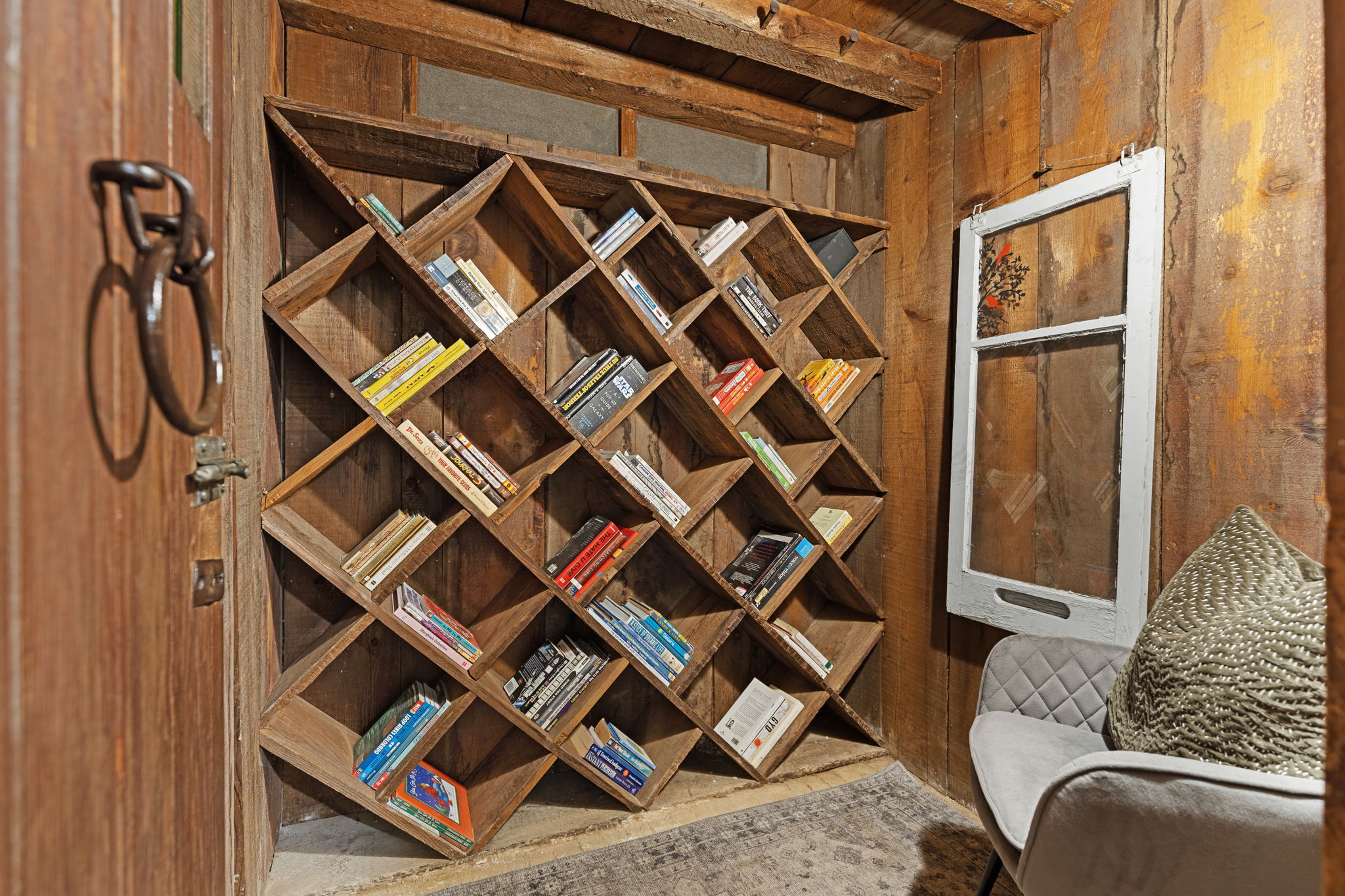 Unique built-in wooden shelving nook featuring diagonal cubbies, perfect for a wine cellaring setup, home library, or specialized storage.