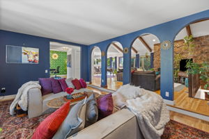 Front sitting room is framed by beautiful arches that separate it from the main living room