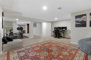Large finished basement offering ample open space for a secondary living room, home office, playroom, fitness, or media space