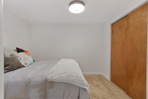 Non-conforming basement bedroom featuring new carpet