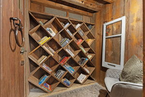 Unique built-in wooden shelving nook featuring diagonal cubbies, perfect for a wine cellaring setup, home library, or specialized storage.