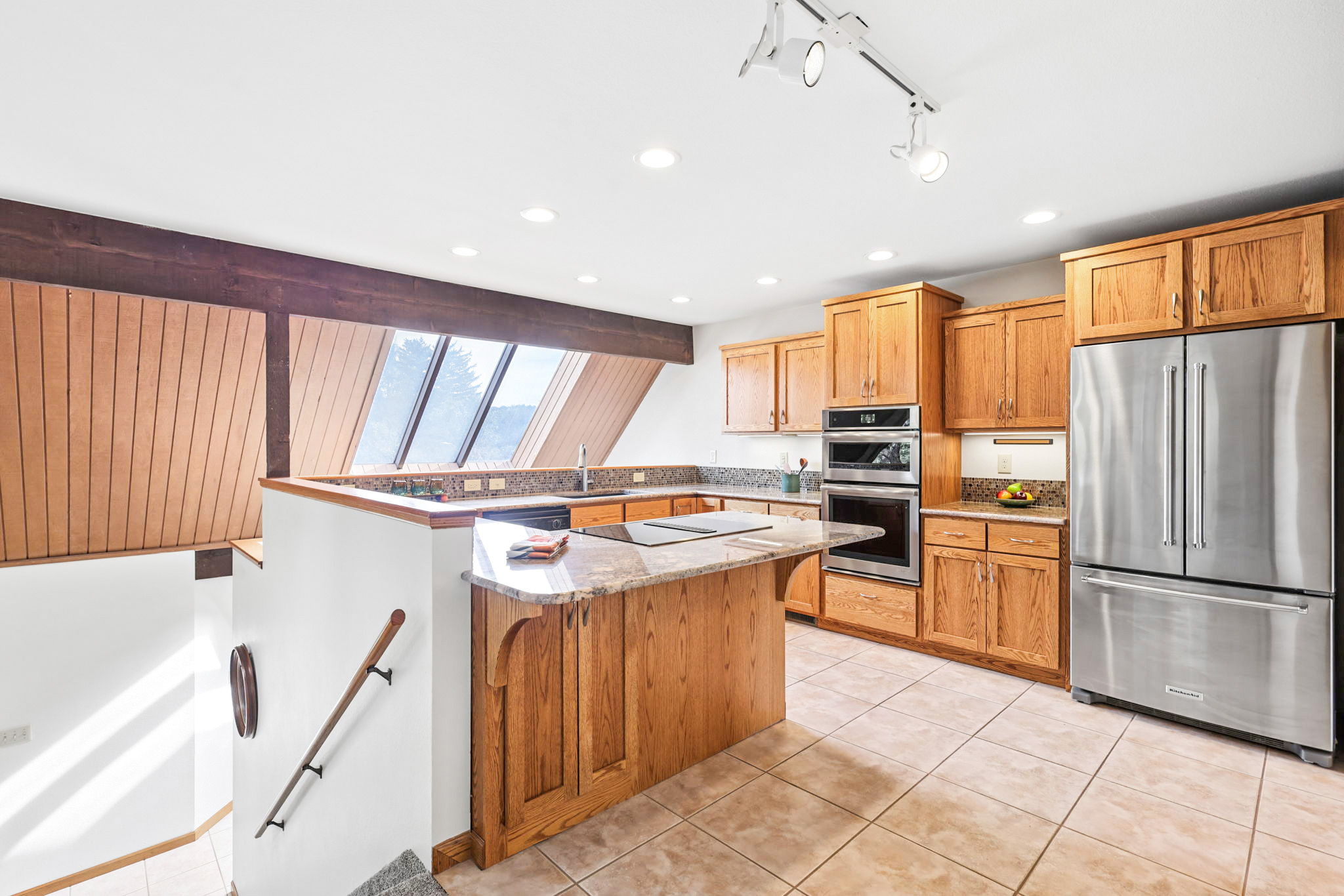 Remodeled kitchen featuring exquisite granite, recessed lighting, and top-rated appliances!