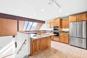 Remodeled kitchen featuring exquisite granite, recessed lighting, and top-rated appliances!