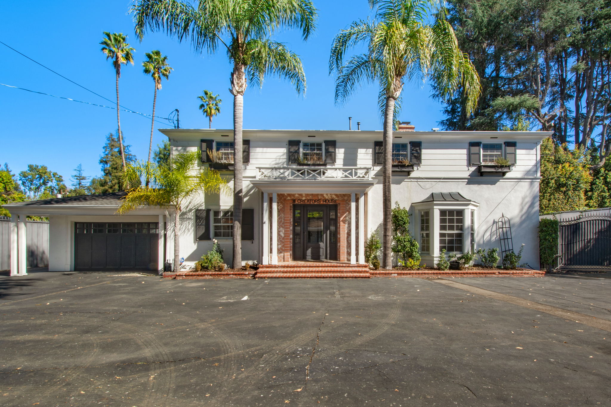 Main house and garage and entry courtyard inside gated premises