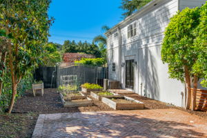 side yard to main home with raised garden beds & irrigation