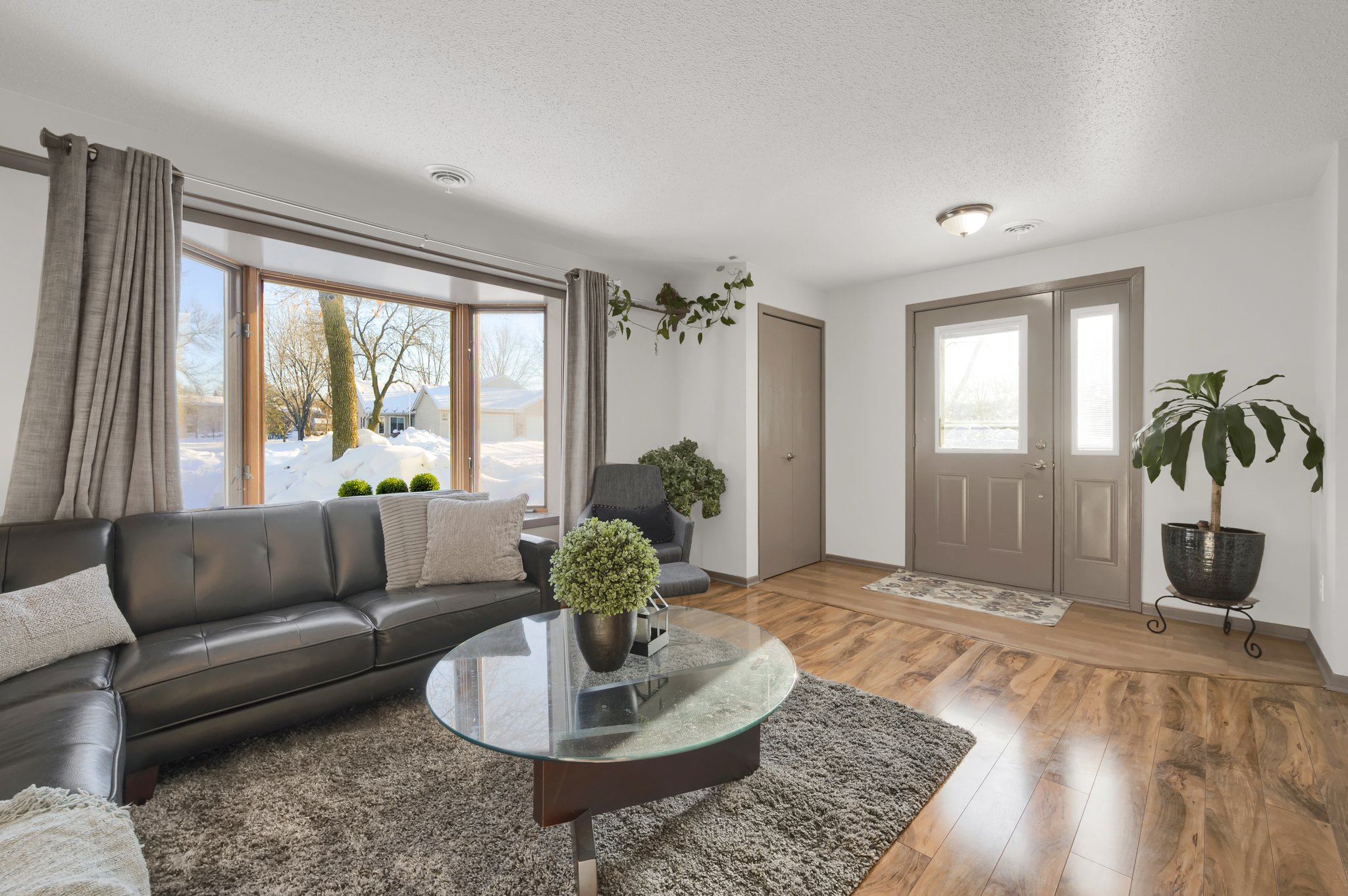 The living room boasts a large bay window that floods the room with natural light!