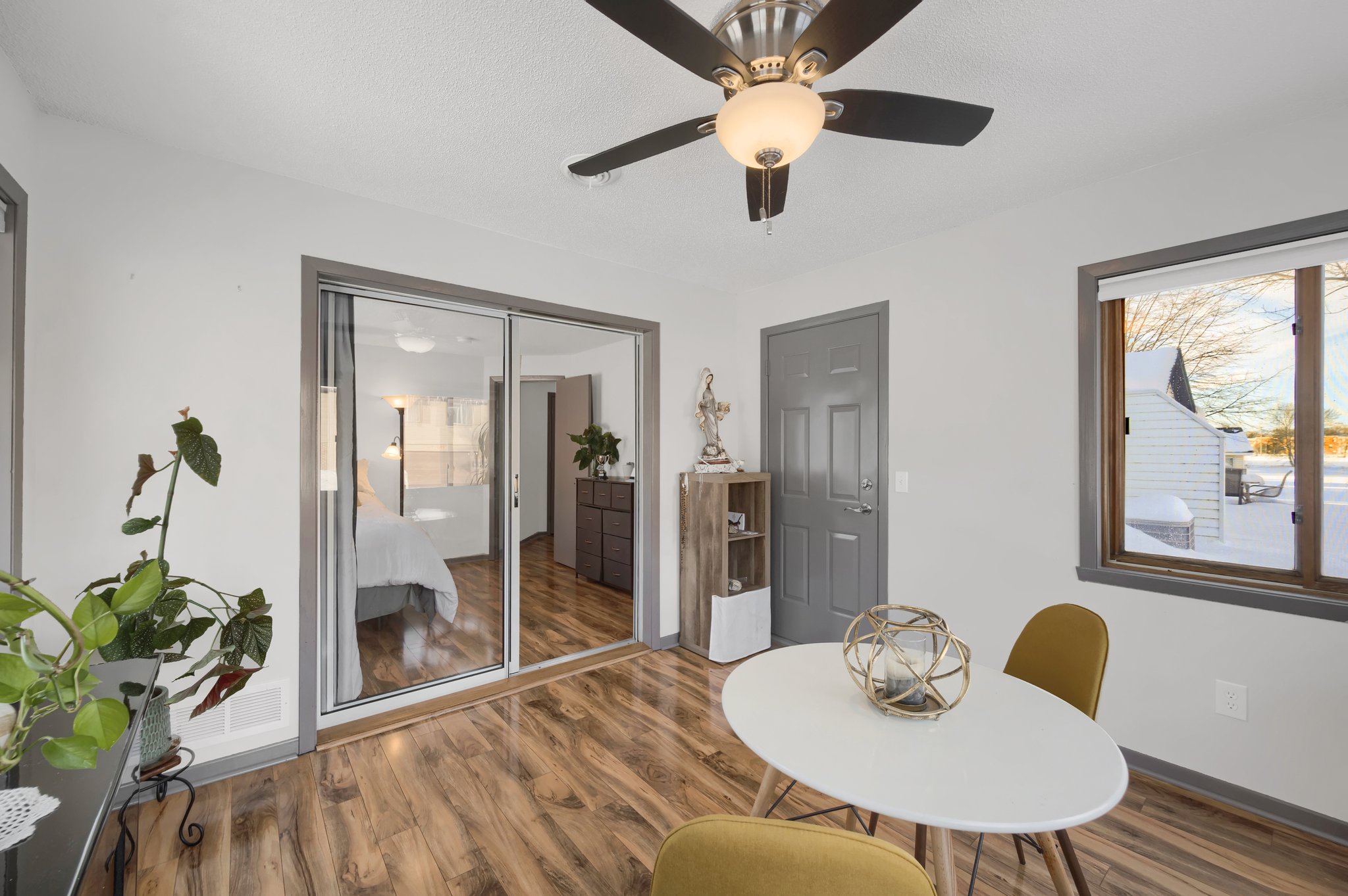 The sunroom offers views of the pond and opens to the back patio for easy outdoor access!