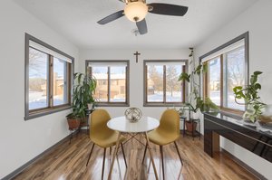 This sunroom is flooded with natural light from windows on three sides, making it a bright and inviting space..!
