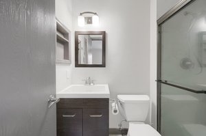 Recently updated primary bathroom, remodeled in July 2022, featuring a new vanity, fixtures, and ceramic tile shower with marble hex floor.