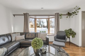 A custom built-in shelf above the bay window offers ample space for displaying plants and knick-knacks.