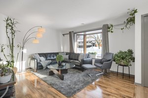 The living room boasts luxury vinyl plank flooring.
