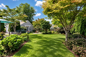 Beautifully Landscaped Backyard – Garage Double Doors Open to a Dedicated Potting Area.
