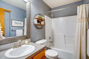 FULL BATH FEATURES TUB WITH SHOWER ABOVE & ONE PIECE SURROUND