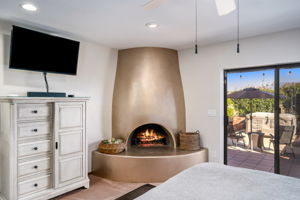 Corner kiva with gas logs in the primary bedroom