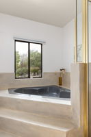 Primary Bathroom with raised soaking tub with a view