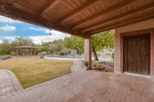 Covered Patio/ Metal door leads to Primary Bedroom
