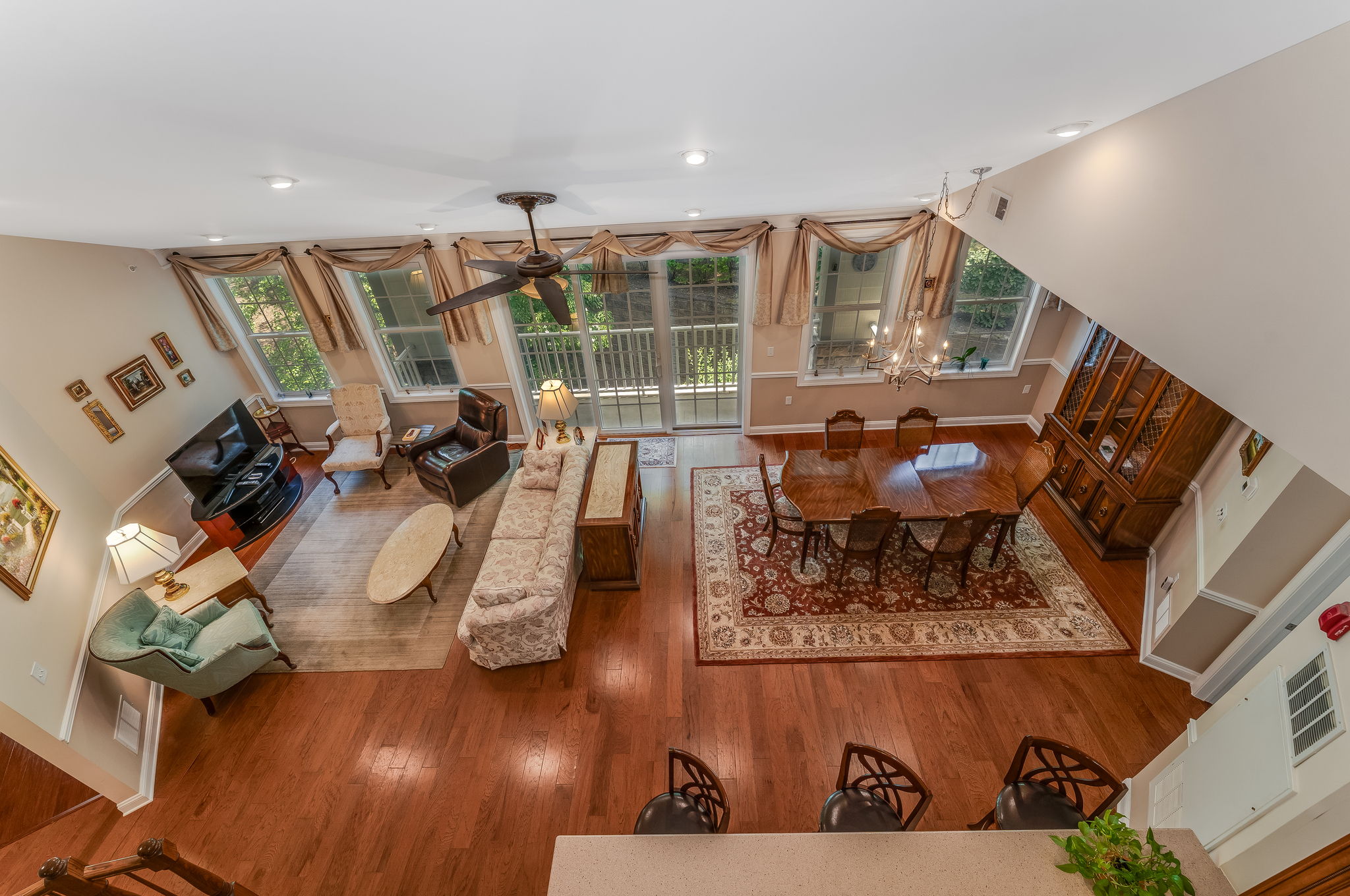 Great Room A soaring ceiling enhances the open and airy great room, where beautiful hardwood floors and recessed lighting define the living and dining areas.