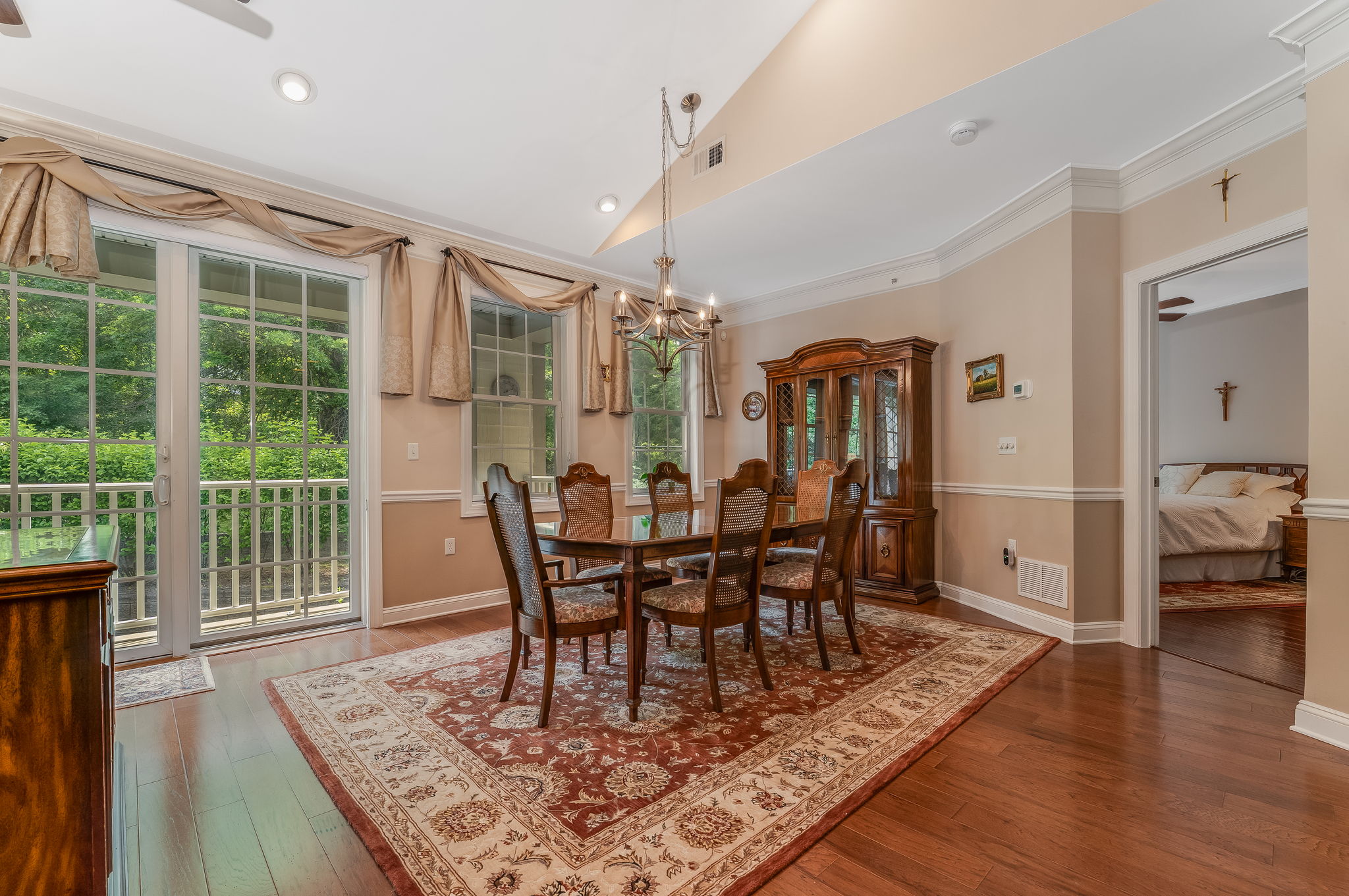 Dining Room A full wall of windows & sliding doors fill the space w natural light & open to a private balcony overlooking a peaceful wooded setting.