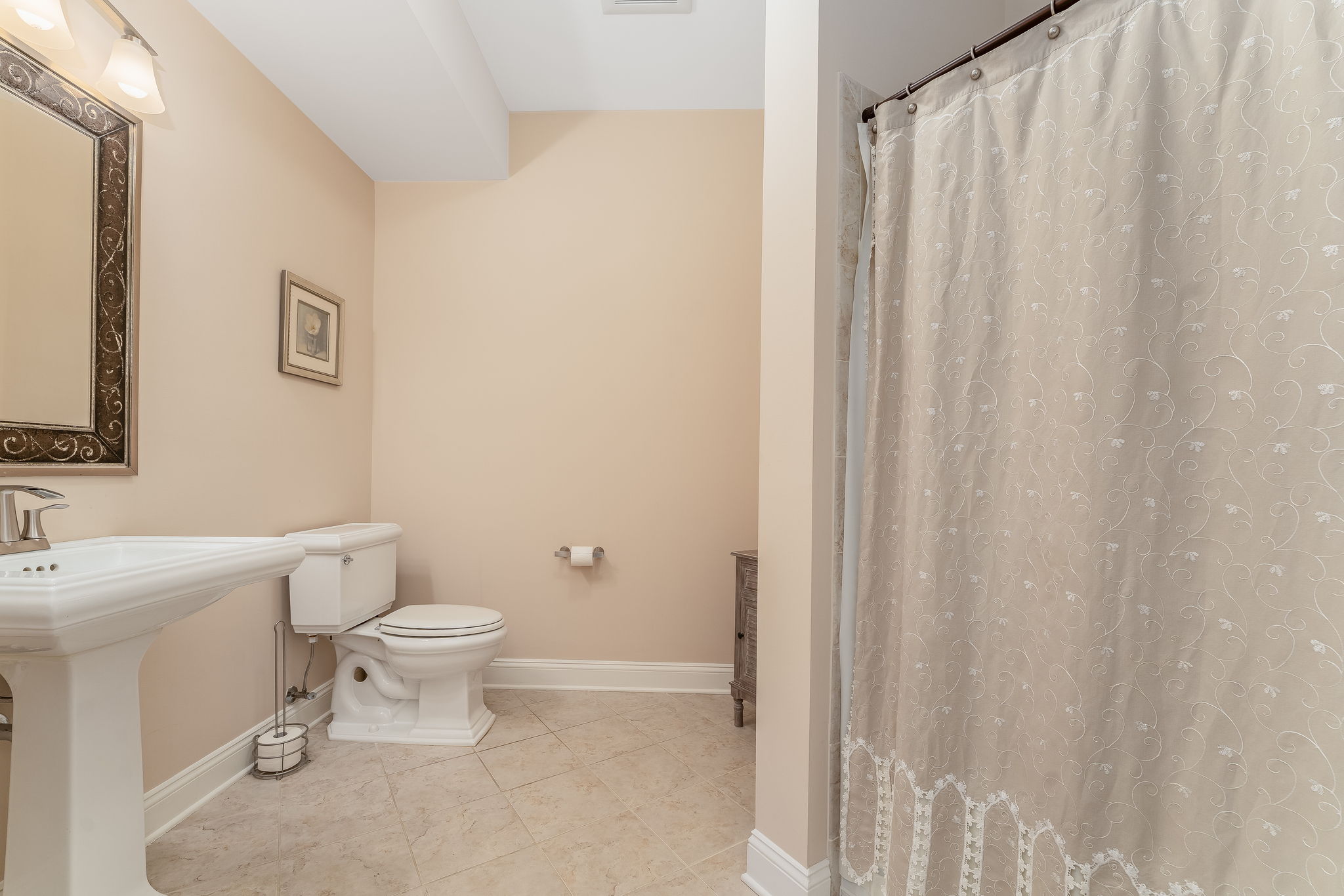 Full Hall Bath The hall bath features a pedestal sink, tub-shower in tile surround and ceramic tile floor.