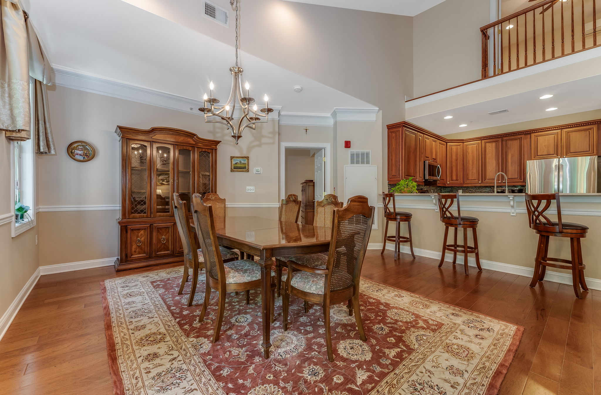 Dining Room A full wall of windows & sliding doors fill the space w natural light & open to a private balcony overlooking a peaceful wooded setting.