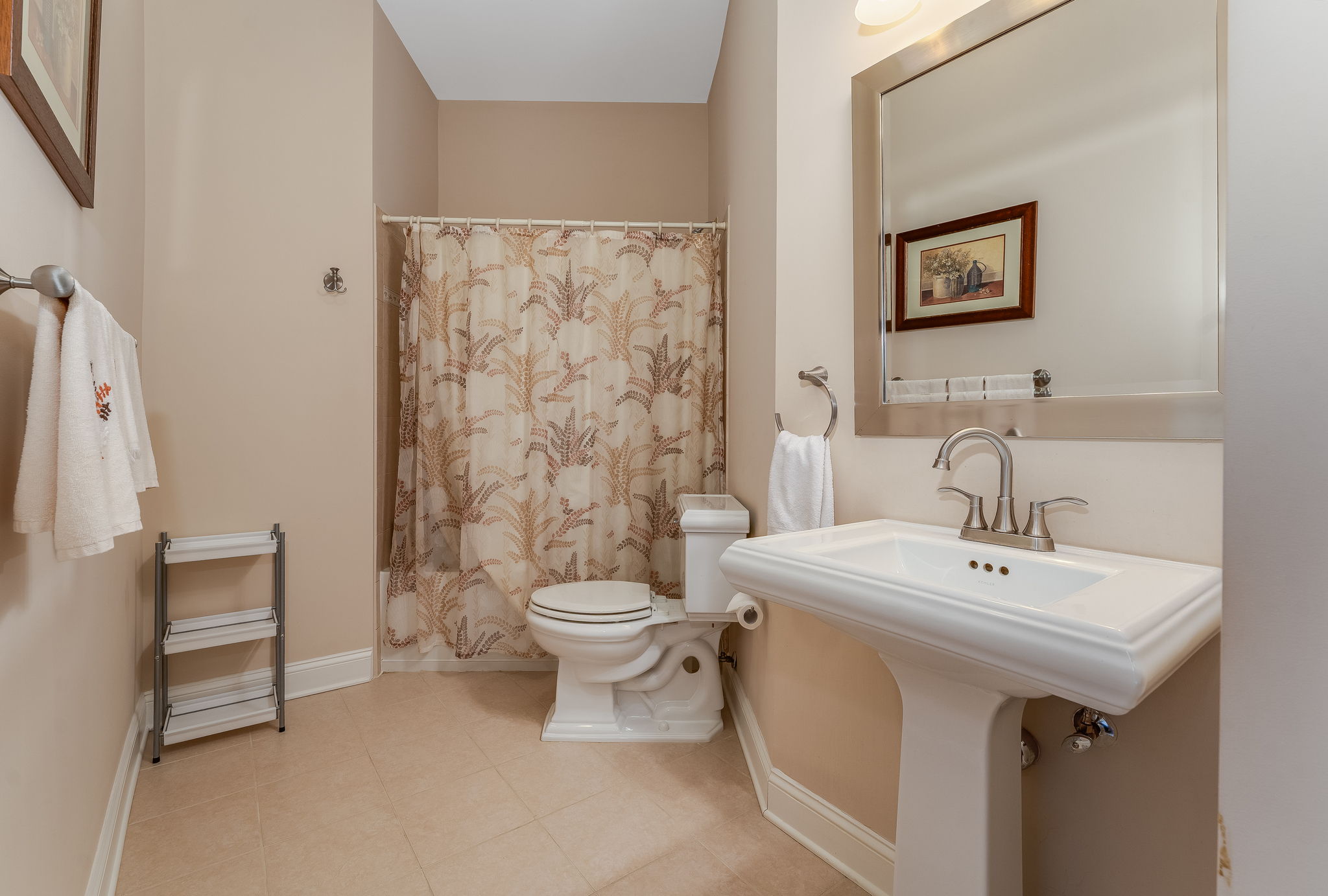 Bathroom 3 The en suite bath features a pedestal sink, tub-shower in tile surround and ceramic tile floor.