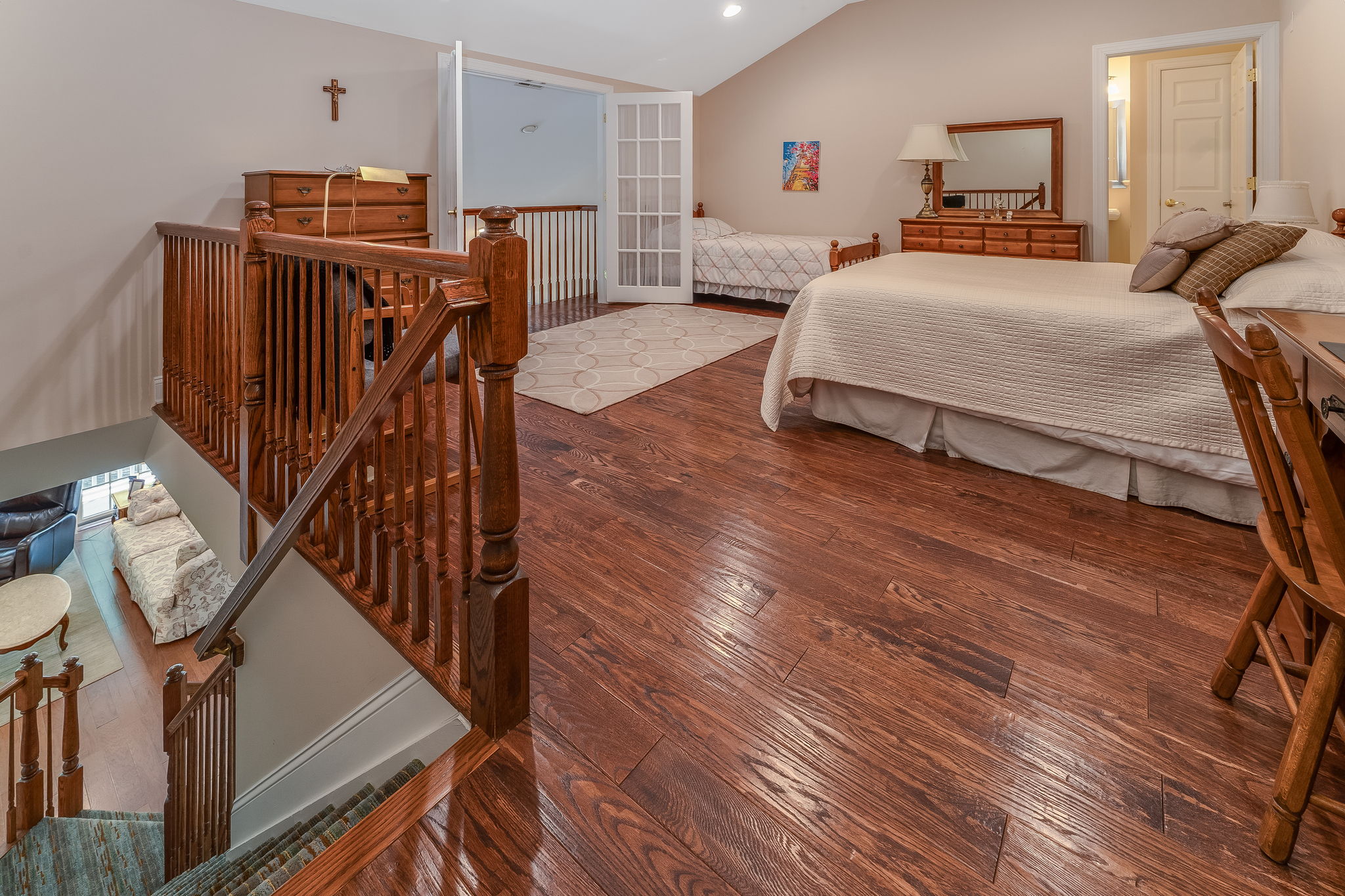 Bedroom 3 This spacious bedroom, complete with a walk-in closet and en suite bath, features French doors that open to a Juliette balcony overlooking the great room below. Other features include re-cessed lighting, ceiling fan and hardwood flooring.