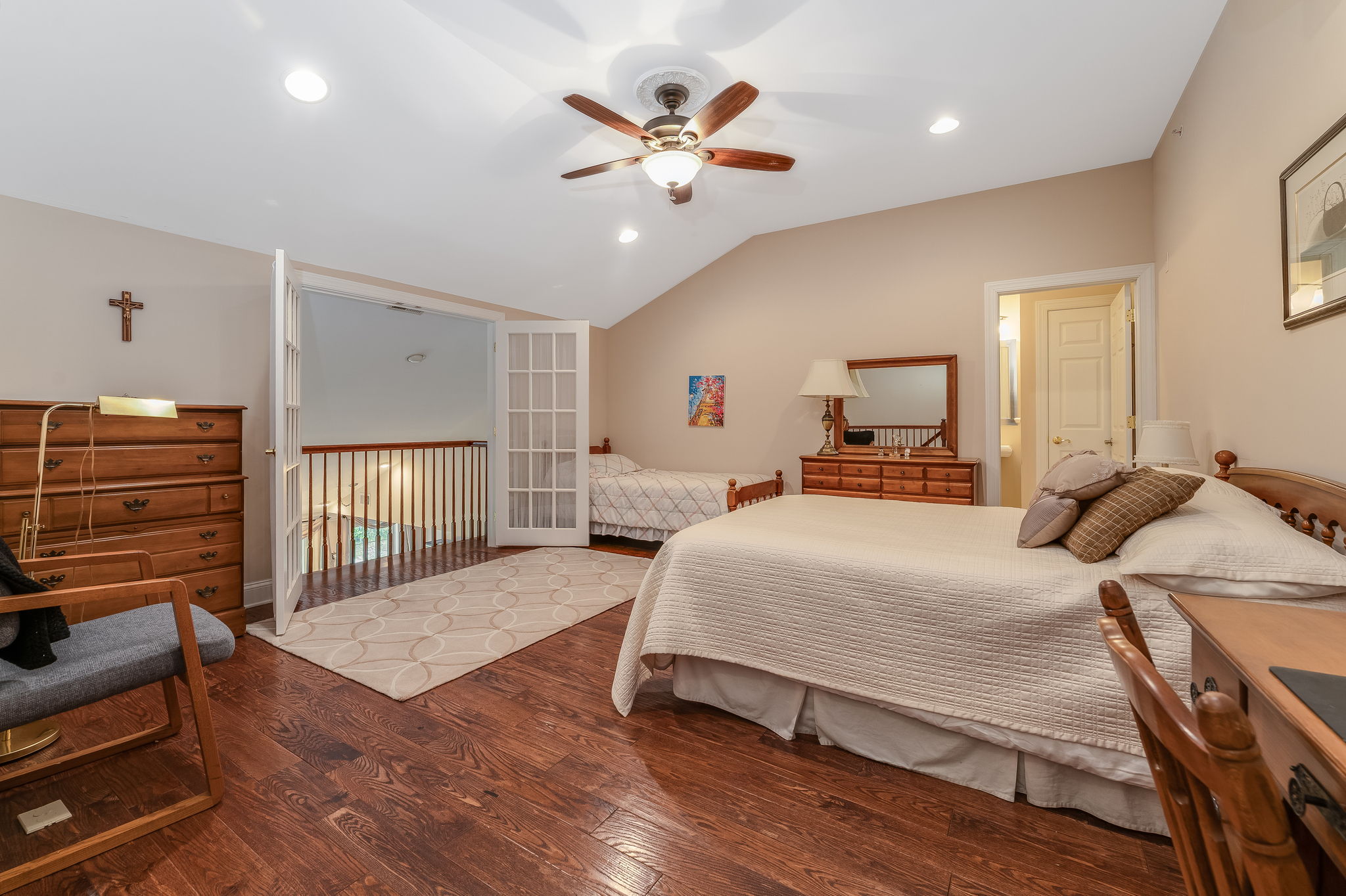 Bedroom 3 This spacious bedroom, complete with a walk-in closet and en suite bath, features French doors that open to a Juliette balcony overlooking the great room below. Other features include re-cessed lighting, ceiling fan and hardwood flooring.