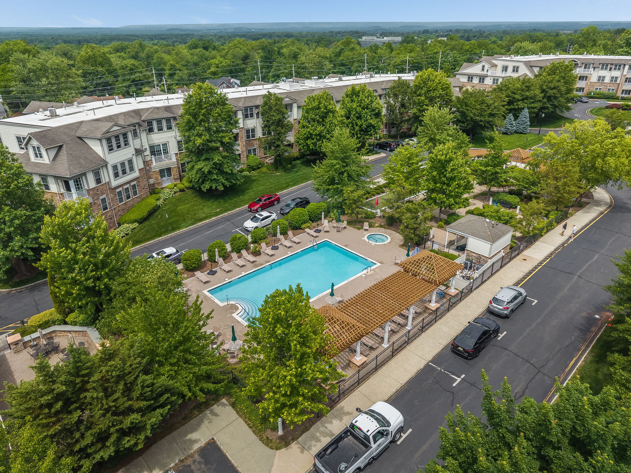 Aerial View of Amenities The meticulously maintained grounds, with colorful Zen-like gardens and a tranquil water-fall fountain creates a peaceful setting for relaxation and socializing.