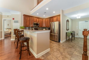 Foyer and Kitchen A raised granite breakfast bar with seating invites casual dining.