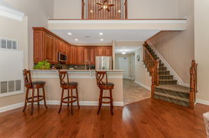 The kitchen features LG stainless steel appliances, abundant 42-inch wood cabinetry, granite countertops, a stacked mosaic backsplash, and ceramic tile floor.